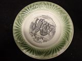 a green plate with a drawing of a man on it