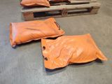 two bags of sand sitting on a pallet in a warehouse