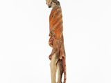 an old wooden statue of a man with long hair and a beard