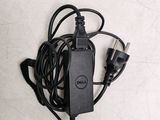 a dell laptop charger plugged into a wall