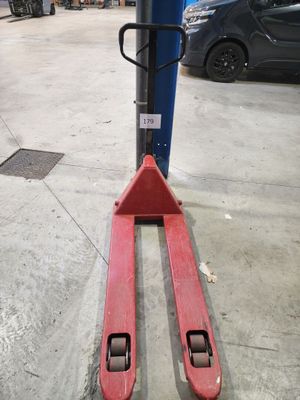 a forklift that is sitting on the ground in the garage