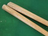 pair of wooden chopsticks sitting on top of a green table