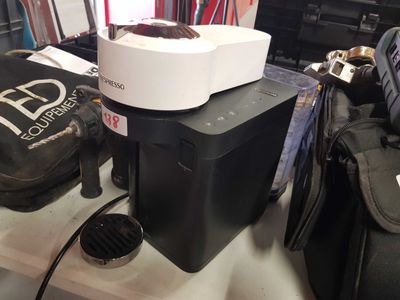 a blender sitting on top of a table next to a bag