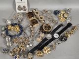 a lot of jewelry that is laying out on the table