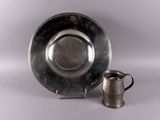 silver plate with a silver cup and saucer on a white background