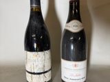 two bottles of wine sitting next to each other on a counter