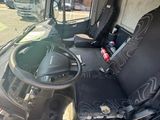 a picture of the inside of a bus with the driver ' s seat up