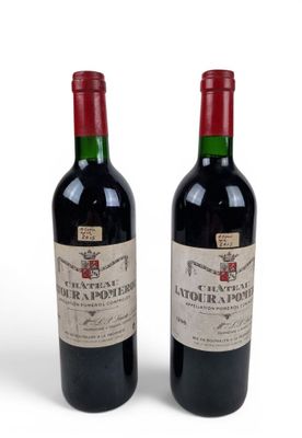two bottles of wine sitting next to each other on a white surface