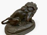 bronze statue of a dog and a cat laying on a base