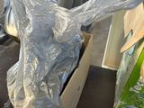 a motorcycle that is wrapped in plastic and sitting on a table
