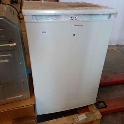 a white refrigerator sitting on top of a pallet in a warehouse
