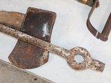 an old rusty axe and a rusty hammer on a table