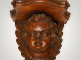 a close up of a carved head of a child on a wall