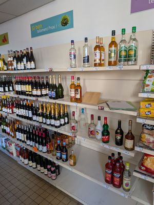 many bottles of alcohol on the shelves in the store