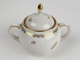 an image of a white and gold teapot with a lid