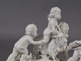 a figurine of a boy and a girl with a goat
