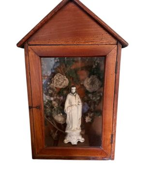 a statue of a woman in a wooden case