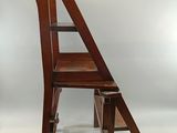 a wooden chair with a ladder on top of it