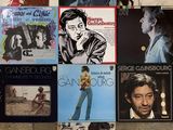 many different album covers on the floor of this room