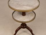two tiered table with marble top and wooden legs