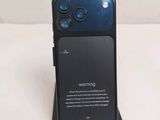 a close up of a cell phone with a warning sign on it