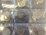 a picture of a display of coins in plastic containers