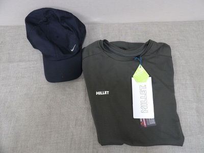 a hat and a t - shirt sitting on a bed
