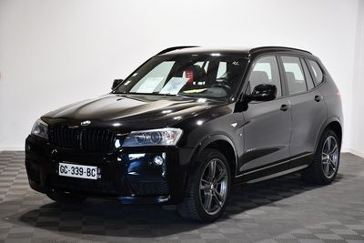 une photo d'un SUV BMW noir garé dans un showroom