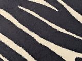 a black and white rug with a zebra pattern on it
