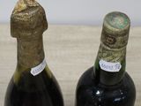 two bottles of wine that are sitting on a table