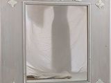 a shadow of a person standing in front of a mirror