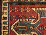 a red and blue rug with a design on it