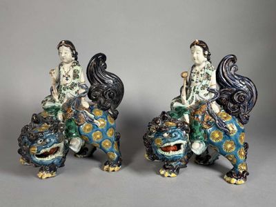 pair of chinese porcelain figurines of a woman and a lion