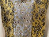 a mannequin dress with a gold and silver pattern on it