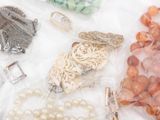 many different types of jewelry on a white surface