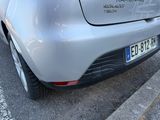 a silver car that is parked on the side of the street