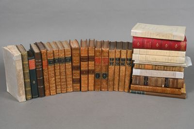 several old books stacked on top of each other on a table