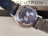 a watch that is sitting on a table next to a book