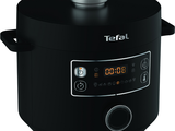 a black electric pressure cooker with a digital clock on it
