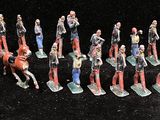 many figurines of people that are standing in a line
