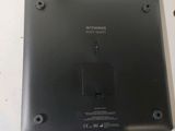 a close up of a laptop with a small button on it