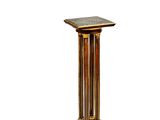 a gold pedestal with a marble top on a white background