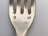 a fork that has a small hole in the middle of it