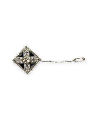 a close up of a diamond broochle on a chain