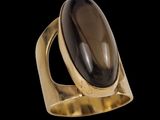 a gold ring with a large black stone in the center