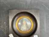 a picture of a woman in a picture frame on the wall