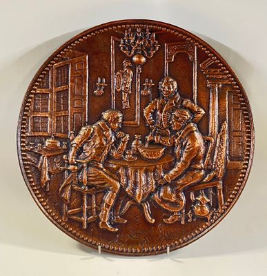 an image of a copper plate with a picture of a man and a woman playing cards