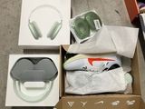 a box of headphones and a pair of shoes on the floor
