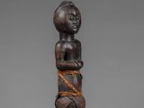 a wooden statue of a man with a rope around his neck