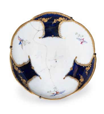 a white plate with blue and gold decoration on it